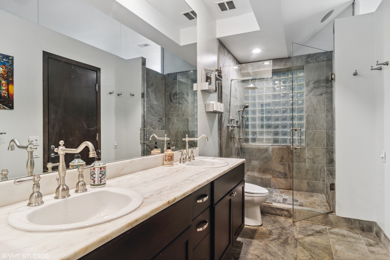 119 West Chestnut Street, Unit 4W Chicago, IL 60610 - Photo 12 of 18 a bathroom with a double vanity sink toilet and shower