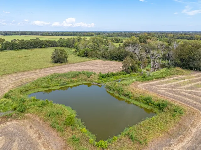 a view of a lake with houses in the back