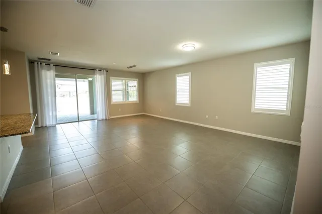 a view of a living room a kitchen and a sink