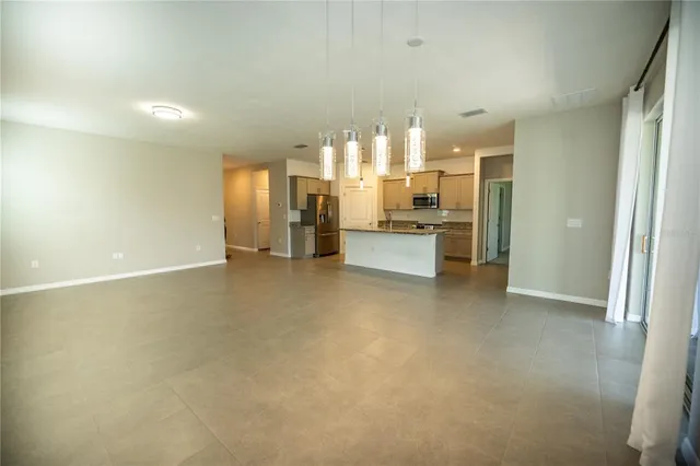 a large kitchen with stainless steel appliances granite countertop a large counter top and a stove top oven