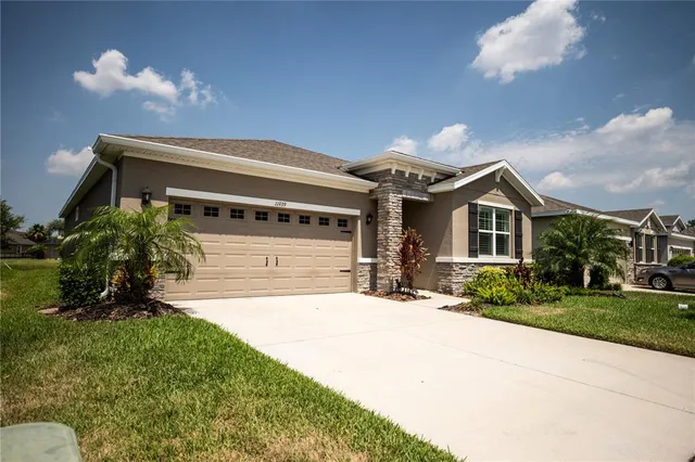 a front view of a house with a yard and garage
