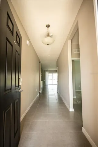 a view of a hallway with a chandelier