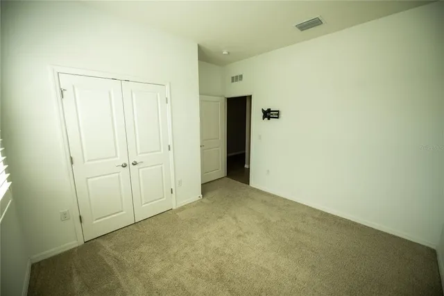 an empty room with closet area