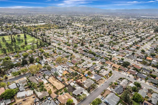 an aerial view of residential building with green space