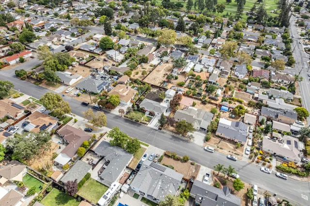 an aerial view of residential houses with city view