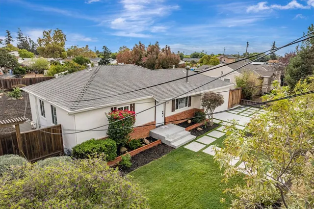 an aerial view of a house with swimming pool garden and patio