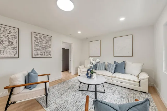 a living room with furniture and wooden floor
