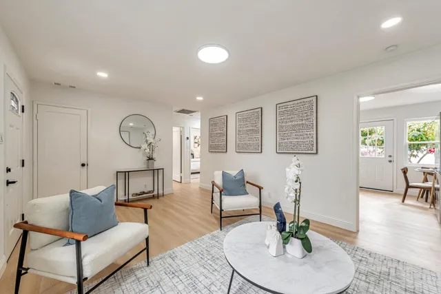a kitchen with cabinets stainless steel appliances a sink and wooden floor