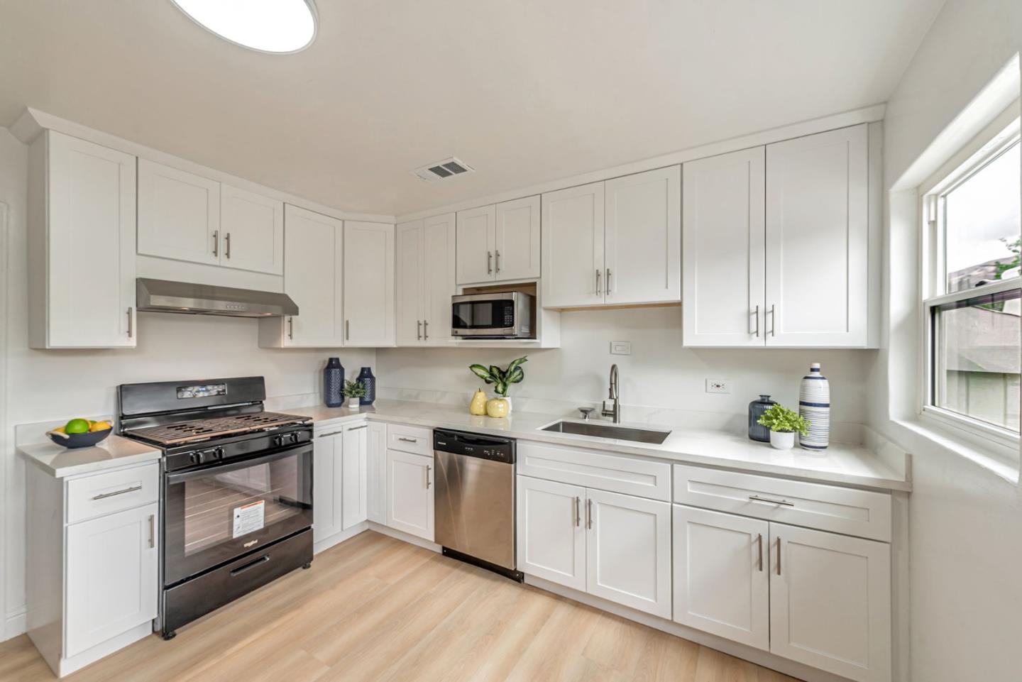 3972 Pepper Tree Lane San Jose, CA 95127 - Photo 26 of 59 a kitchen with cabinets stainless steel appliances a sink and wooden floor