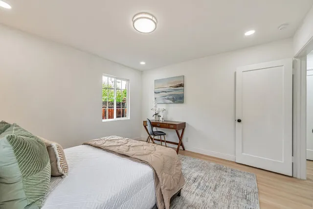 a bedroom with a bed and a window