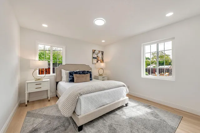 a bed room with a bed and a view of kitchen