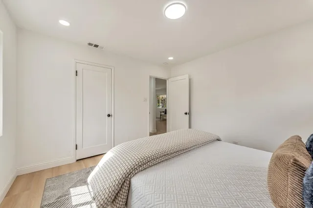 a bedroom with a bed and a chair