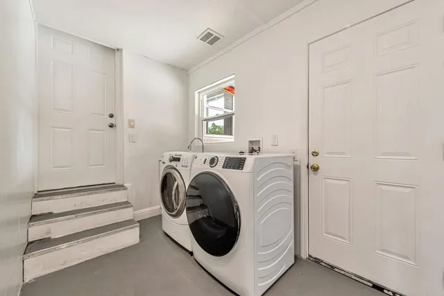 a front view of a house with a garden and patio