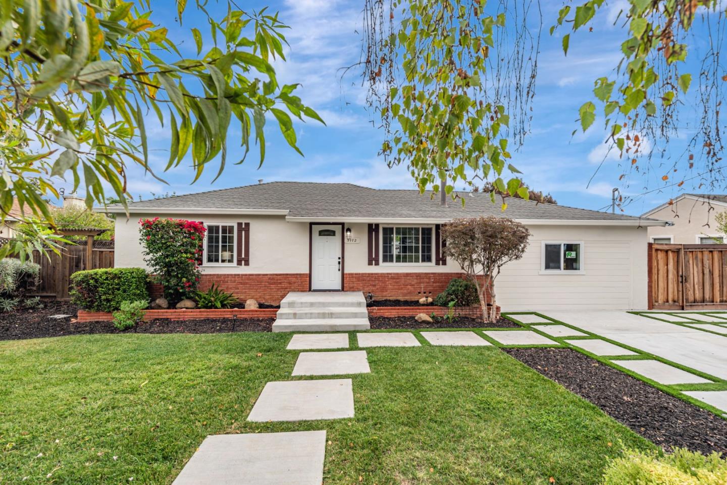 3972 Pepper Tree Lane San Jose, CA 95127 - Photo 5 of 59 a front view of a house with a garden and trees