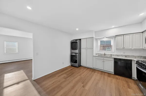 a kitchen with stainless steel appliances granite countertop a refrigerator a stove and a sink