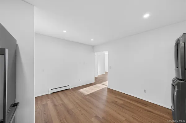 an empty room with wooden floor and a window