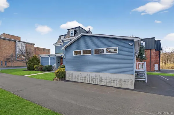 a view of a house with a yard and garage