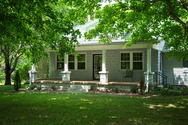 a view of a field of grass and trees