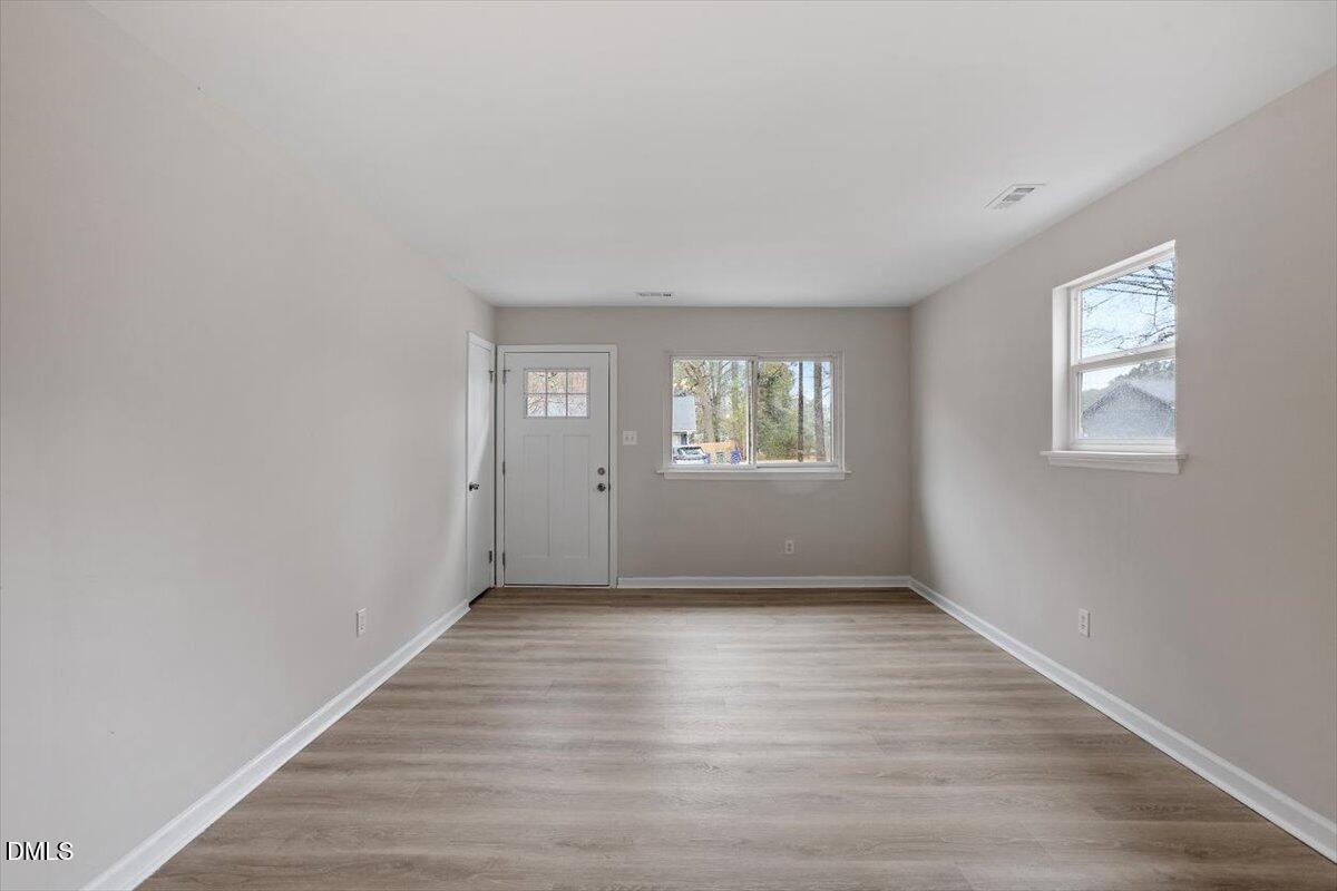 3306 Prudence Street Durham, NC 27704 - Photo 11 of 22 a view of an empty room with wooden floor and a window