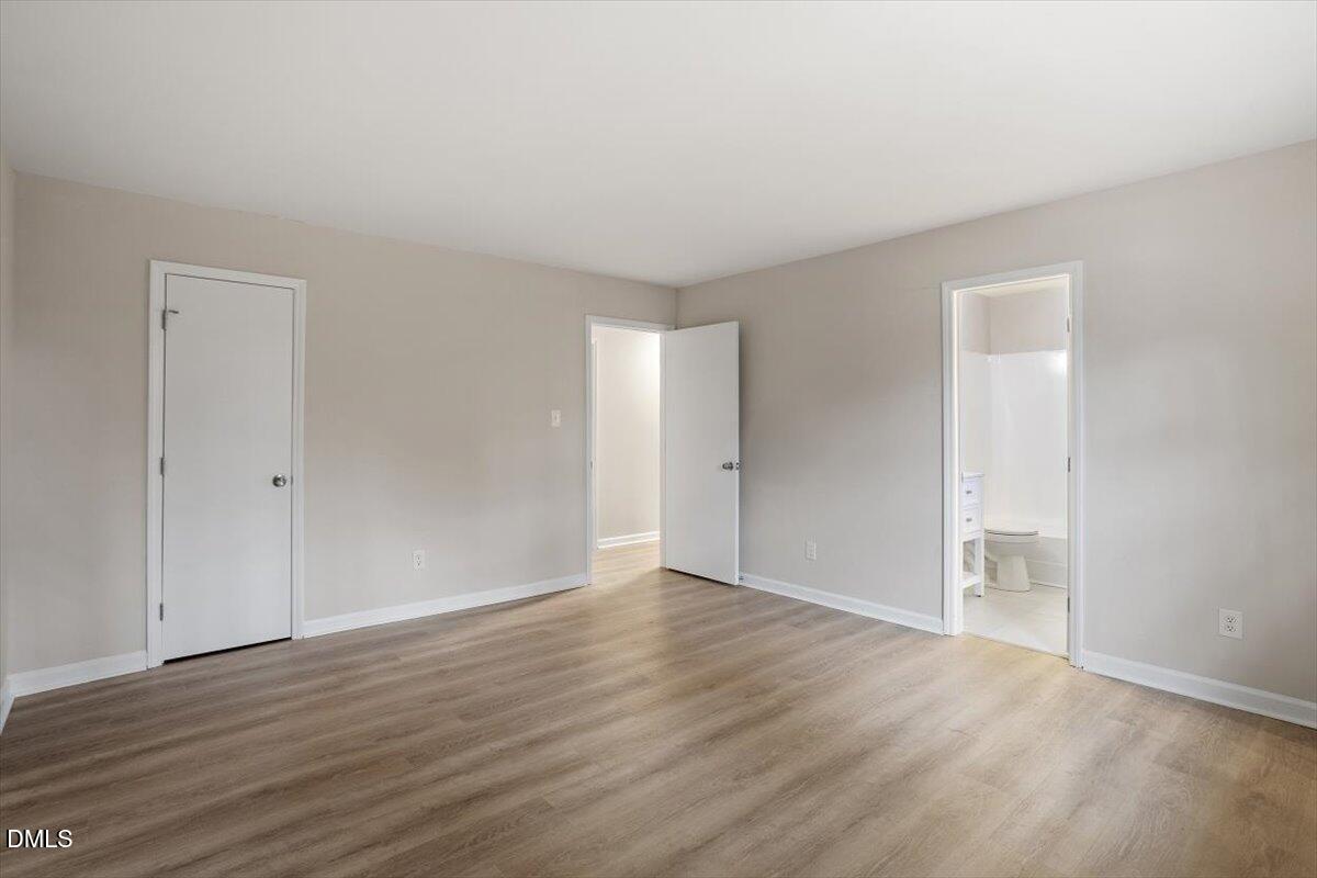 3306 Prudence Street Durham, NC 27704 - Photo 14 of 22 a view of an empty room with wooden floor and closet