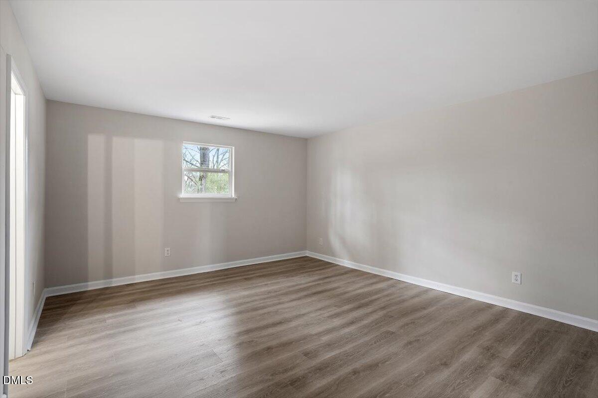 3306 Prudence Street Durham, NC 27704 - Photo 15 of 22 an empty room with wooden floor and window