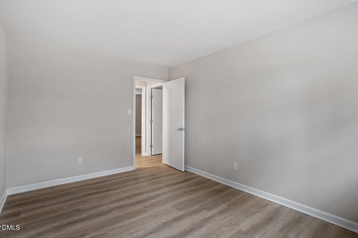 3306 Prudence Street Durham, NC 27704 - Photo 18 of 22 a view of an empty room with wooden floor