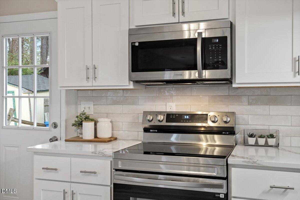 3306 Prudence Street Durham, NC 27704 - Photo 2 of 22 a kitchen with appliances a sink and cabinets