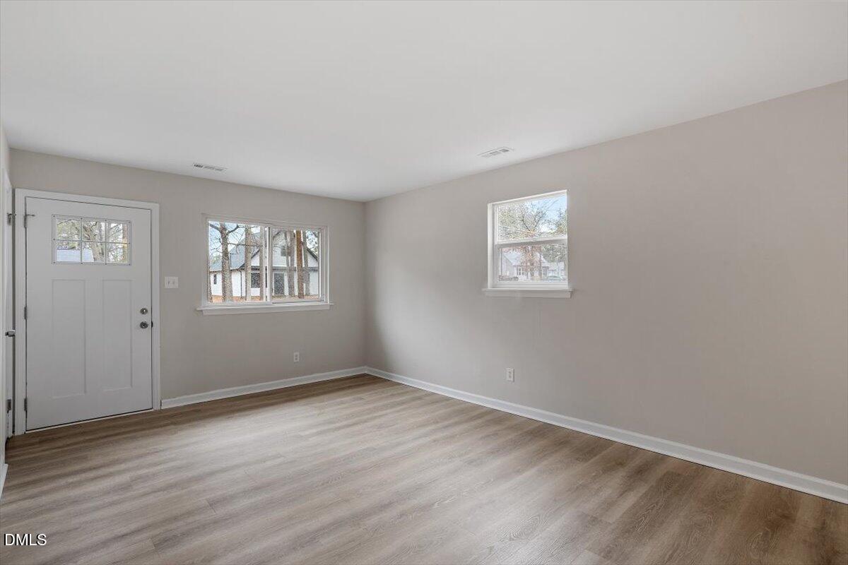3306 Prudence Street Durham, NC 27704 - Photo 8 of 22 wooden floor in an empty room with a window