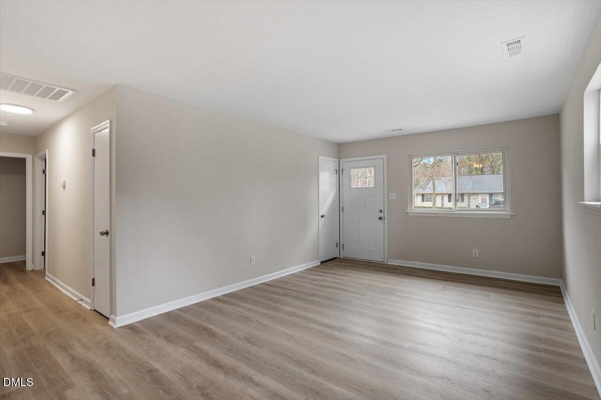 3306 Prudence Street Durham, NC 27704 - Photo 10 of 22 an empty room with wooden floor and windows