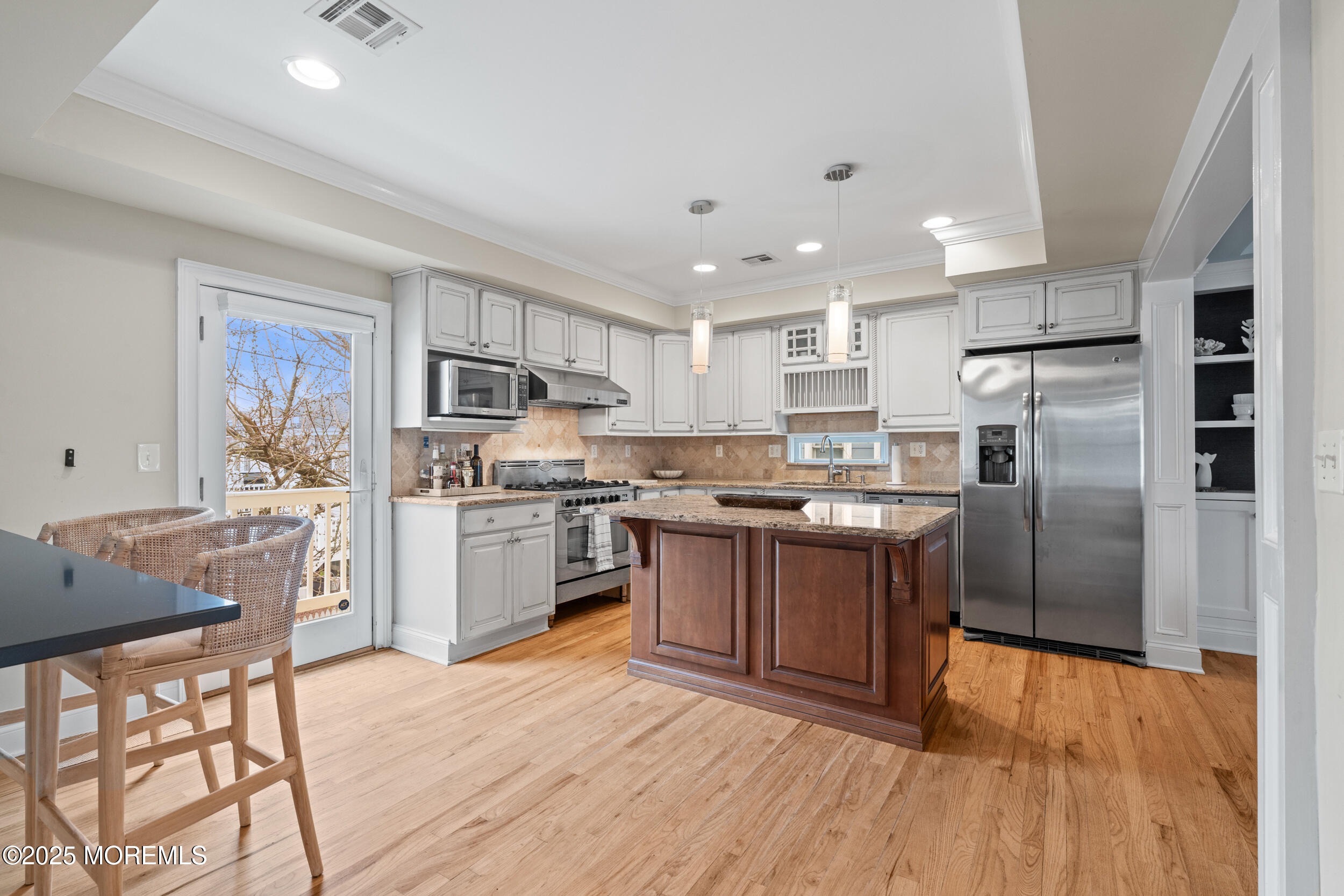 5 Shrewsbury Way Sea Bright, NJ 07760 - Photo 22 of 59 a kitchen with stainless steel appliances granite countertop a refrigerator a stove top oven a sink dishwasher and white cabinets with wooden floor