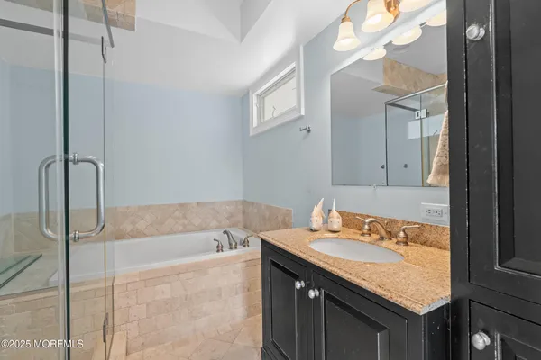 a bathroom with a bathtub and a shower