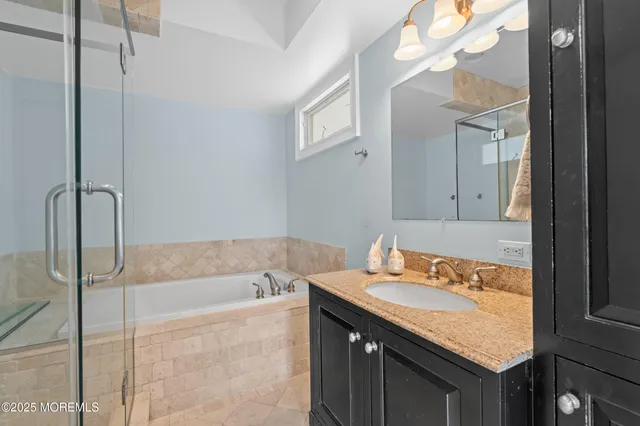 a bathroom with a bathtub and a shower