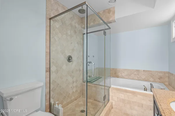 a bathroom with a bathtub and a shower