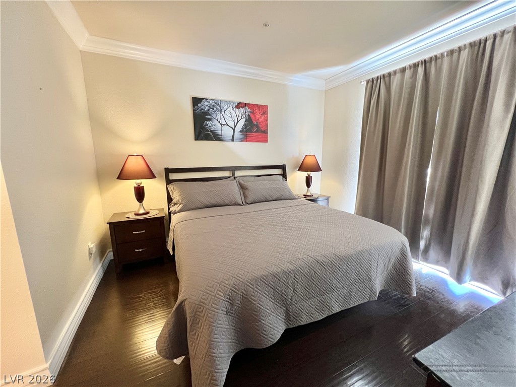 270 East Flamingo Road, Unit 313 Las Vegas, NV 89169 - Photo 9 of 27 Rich hardwood floors complement this cozy bedroom with elegant crown molding.