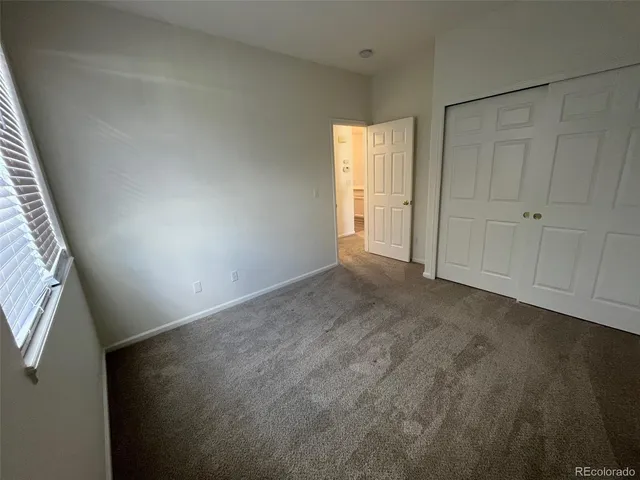 a view of an empty room and a window