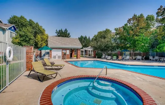 a view of pool with lawn chairs and a yard