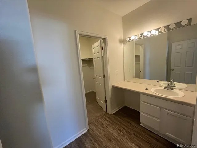 a bathroom with a double vanity sink mirror and toilet