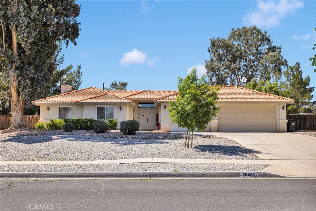 20403 Ochoa Road Apple Valley, CA 92307 - Photo 2 of 48 a front view of a house with a yard and garage
