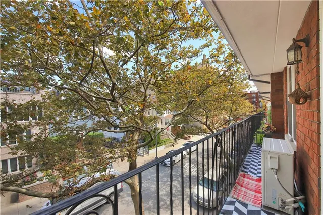 a view of balcony with wooden floor and fence