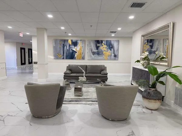 a living room with a couch and a potted plant