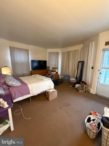 a bedroom with a bed and a chair