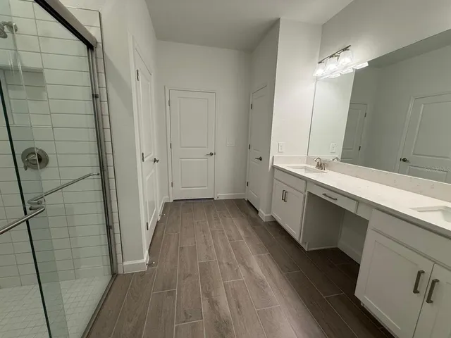 a bathroom with a double vanity sink and mirror