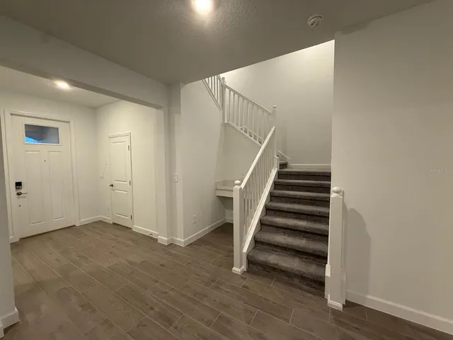 a view of kitchen with stainless steel appliances a refrigerator sink and cabinets