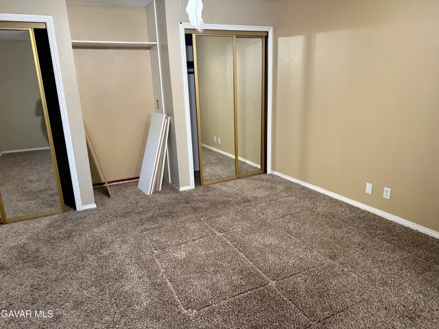 an empty room with a mirror