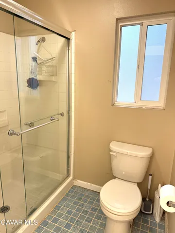 a white toilet sitting next to a bathroom sink