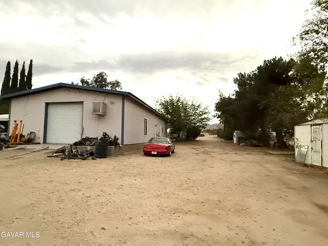 a view of a house with a snow on the road