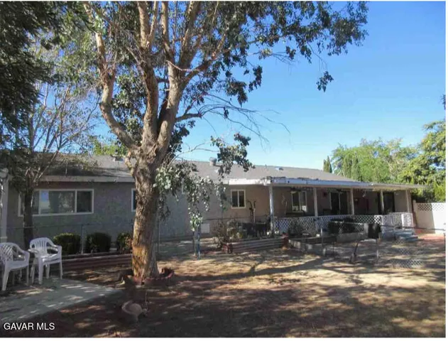 a backyard of a house with yard barbeque oven and outdoor seating