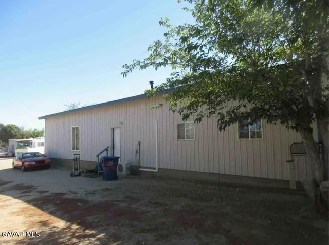 a view of backyard with parked car