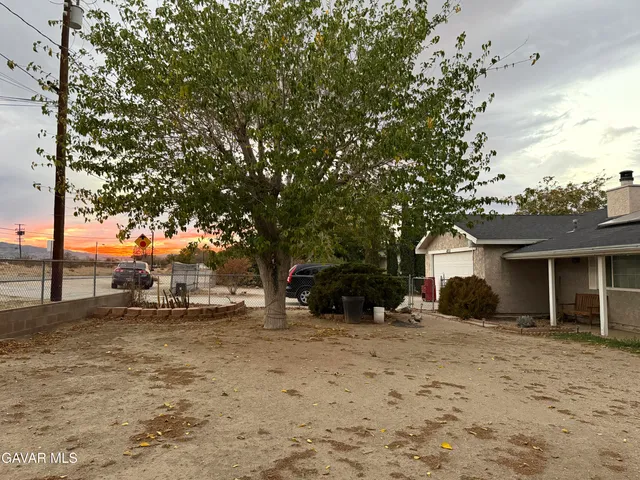 a view of a house with a yard covered in snow