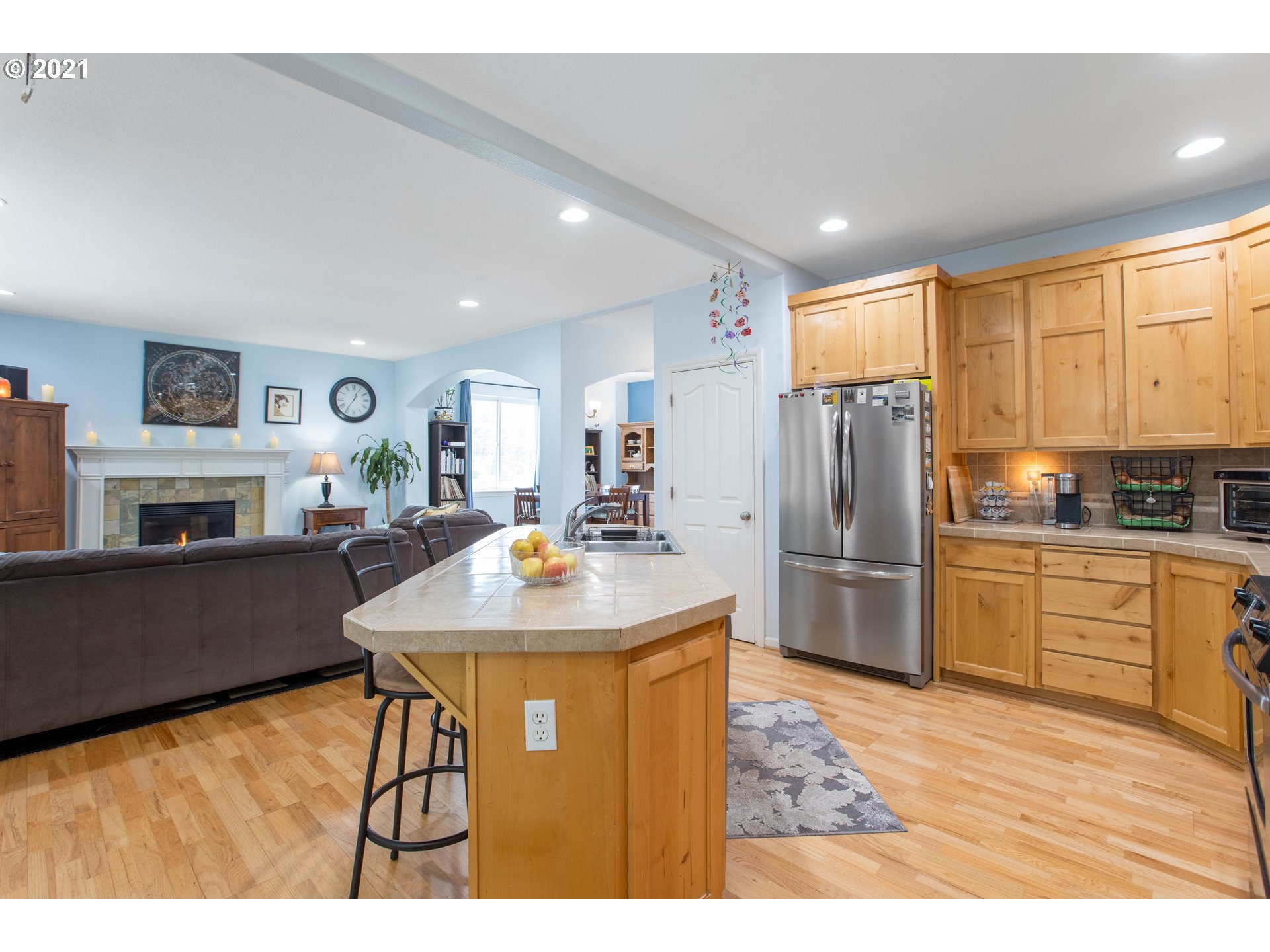 19485 Hummingbird Loop Oregon City, OR 97045 - Photo 14 of 30 a kitchen with stainless steel appliances kitchen island granite countertop a refrigerator a stove a sink dishwasher with a dining table and chairs